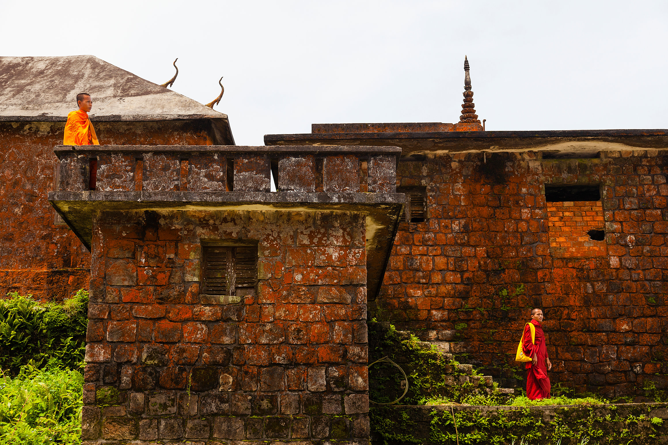 Buddhist monks and Wat Sampov Pram pagoda on Bokor Mountain - Kampot, Cambodia