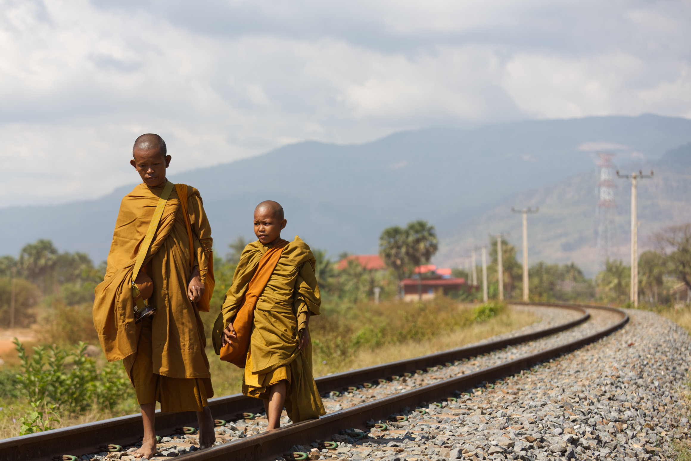 Two Buddhist monks on Bokor railway in Kampot, Cambodia