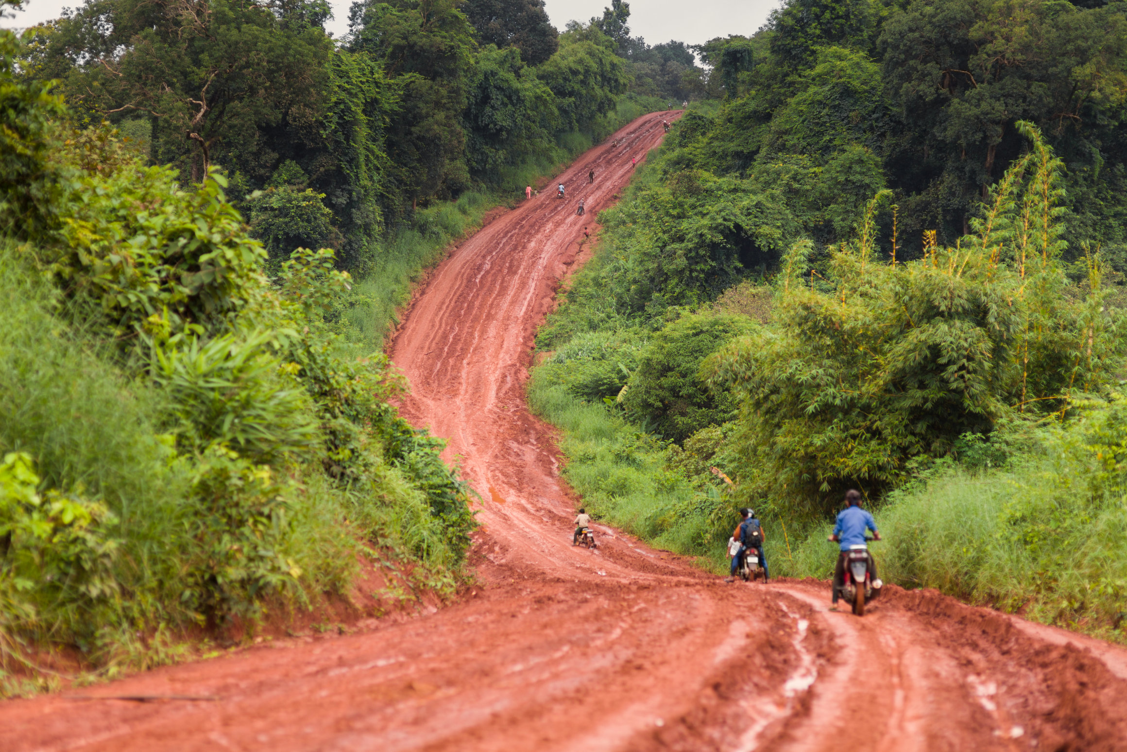 Motobike adventure on muddy slope in Ratanakiri, Cambodia