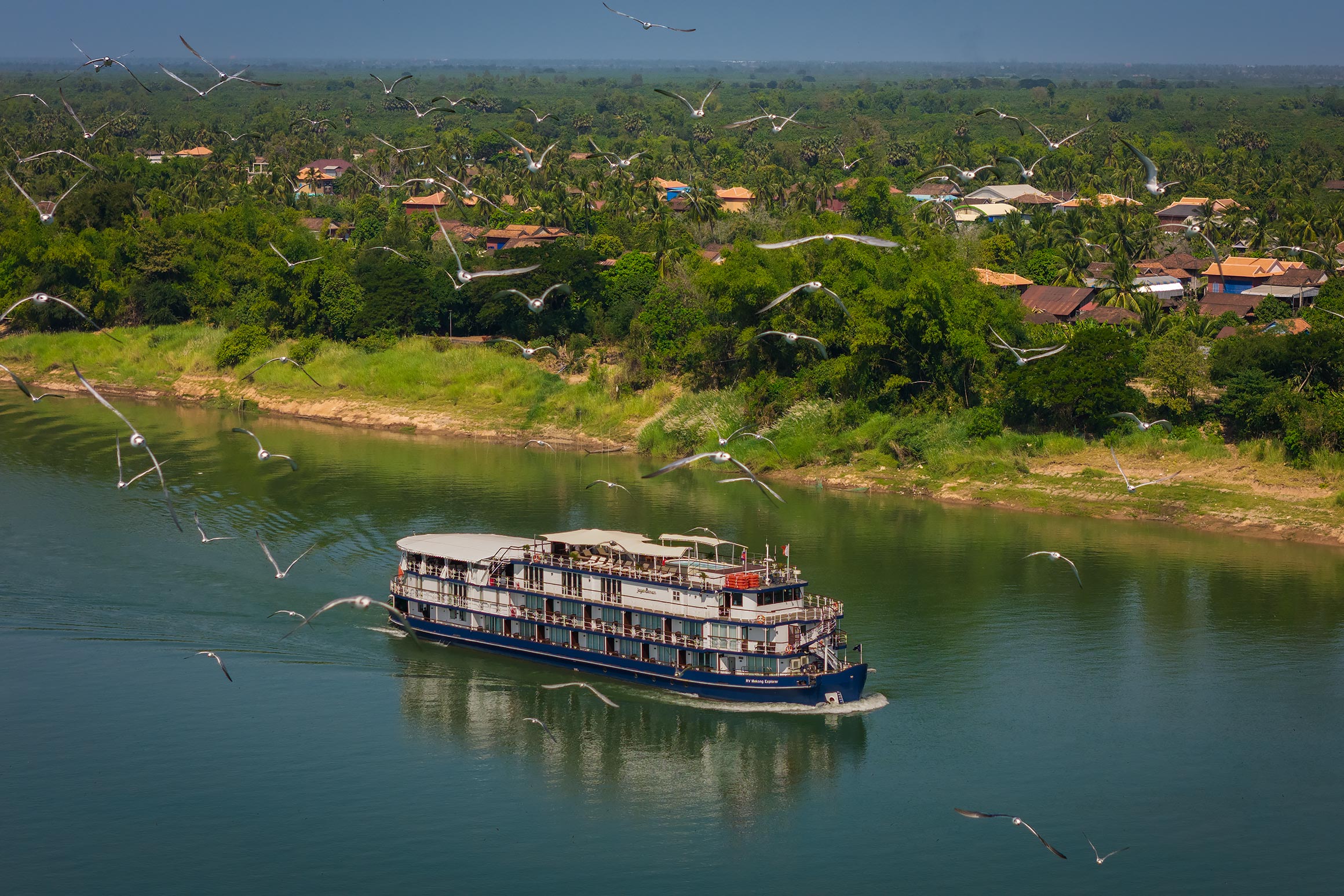 Cambodian luxury cruise ship along Cambodian countryside | Drone Photographer in Phnom Penh