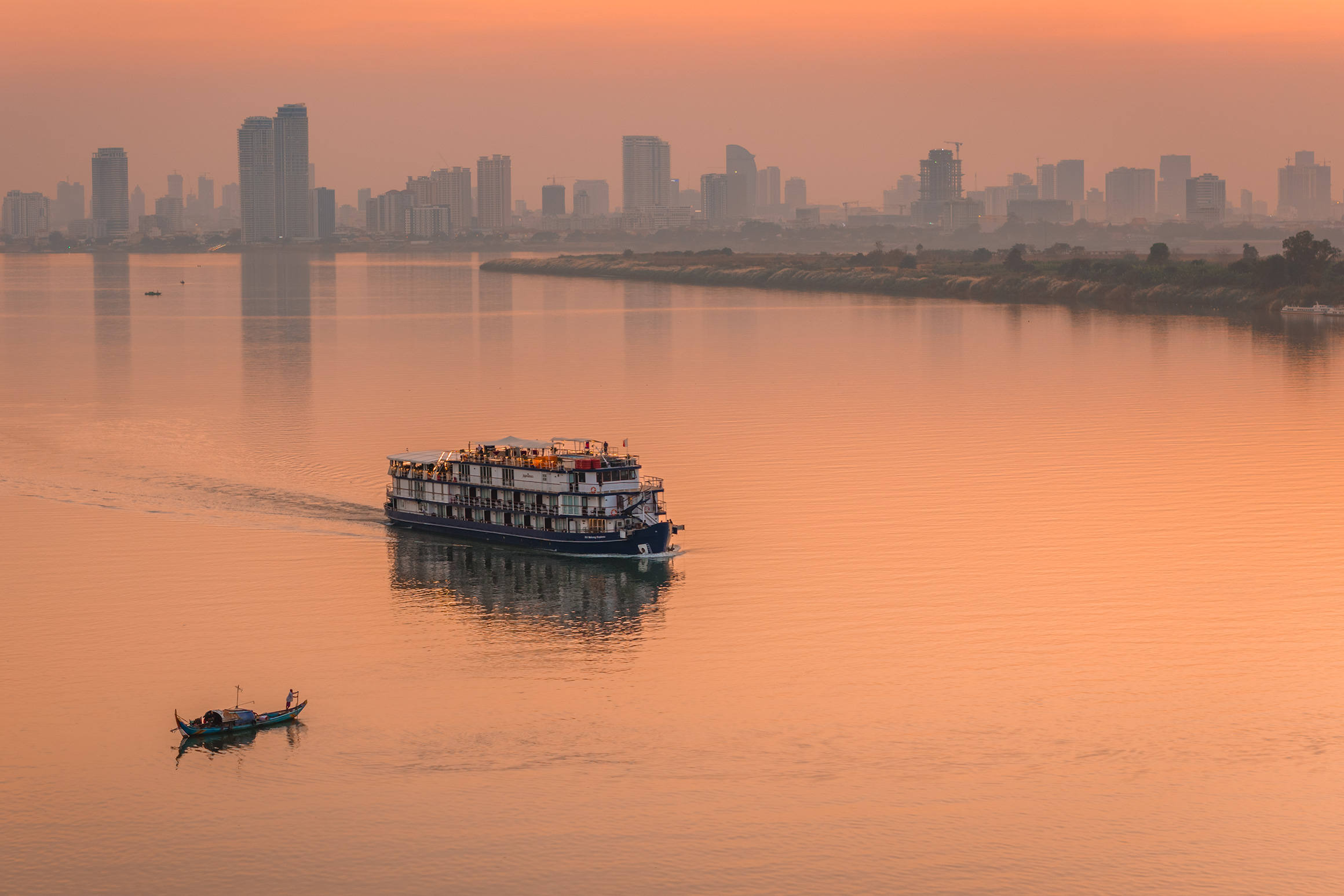 Phnom Penh skyline and cruise boat on the Tonle Sap River | Professional aerial photographer in Cambodia